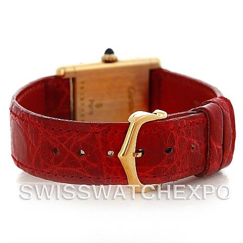 The image shows the backside and clasp of the Cartier Tank Classic Women's Yellow Gold White Dial Women's Yellow Gold White Dial watch, highlighting its red leather strap and gold buckle.