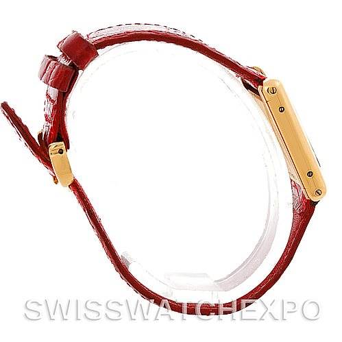 This image shows a side view of the Cartier Tank Classic Women's Yellow Gold White Dial Women's Yellow Gold White Dial watch, highlighting its gold case and red leather strap.