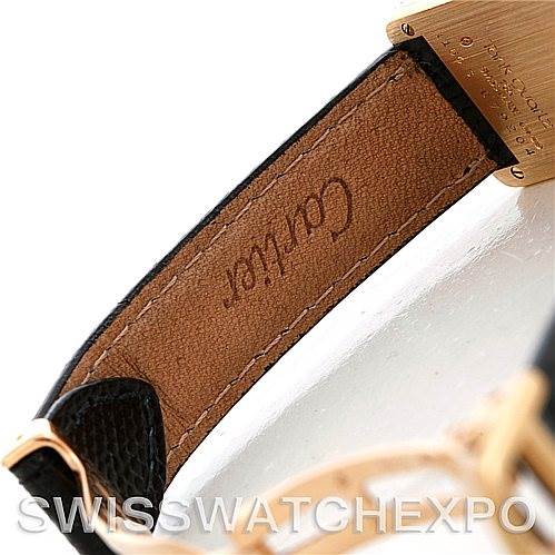 The image shows a close-up of the Cartier Tank Classic Women's Yellow Gold Silver Dial Women's Yellow Gold Silver Dial watch's leather strap and part of the buckle.