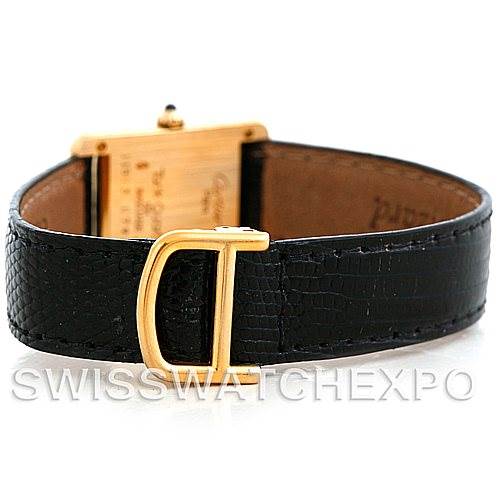 The image shows the back of a Cartier Tank Classic Women's Yellow Gold Silver Dial Women's Yellow Gold Silver Dial watch, highlighting the leather strap and gold buckle.