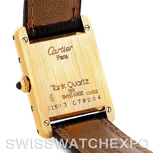 This image shows the back case and leather strap of the Cartier Tank Classic Women's Yellow Gold Silver Dial Women's Yellow Gold Silver Dial watch, focusing on the inscriptions and the buckle area.