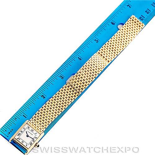 The Cartier Tank Classic Women's Yellow Gold Silver Dial Women's Yellow Gold Silver Dial watch is photographed from above, showing the face and full length of the gold bracelet next to a ruler.