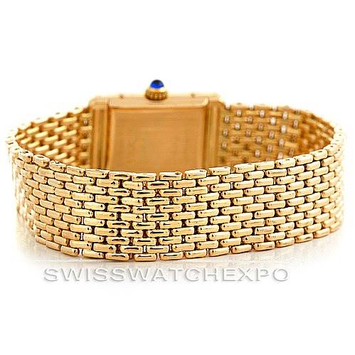 This image shows the back view of a Cartier Tank Classic Women's Yellow Gold Silver Dial Women's Yellow Gold Silver Dial watch, highlighting its gold bracelet and case.