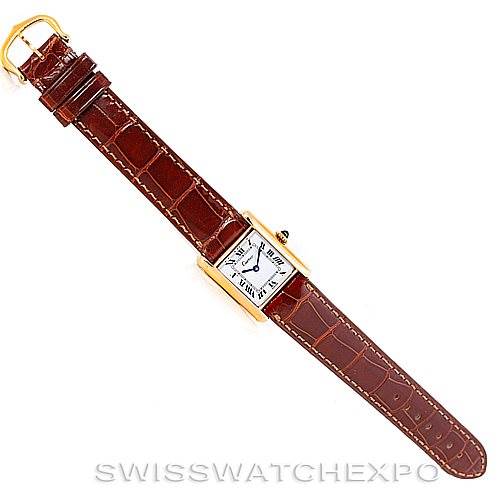The image shows a top-down view of a Cartier Tank Classic Women's Yellow Gold White Dial Women's Yellow Gold White Dial watch with a brown leather strap and gold case.