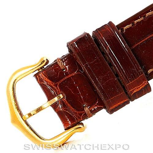 This image shows a close-up of the brown leather strap and gold buckle of the Cartier Tank Classic Women's Yellow Gold White Dial Women's Yellow Gold White Dial watch.