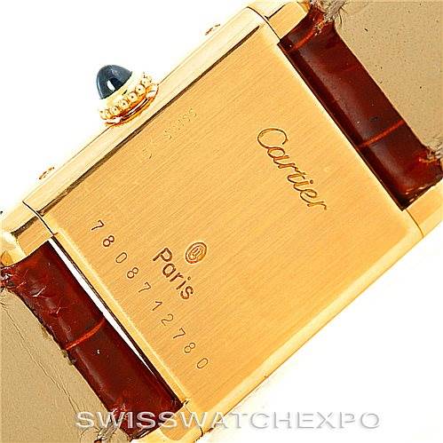 This image shows the back of the Cartier Tank Classic Women's Yellow Gold White Dial Women's Yellow Gold White Dial watch, highlighting the engraved details and the strap attachment points.