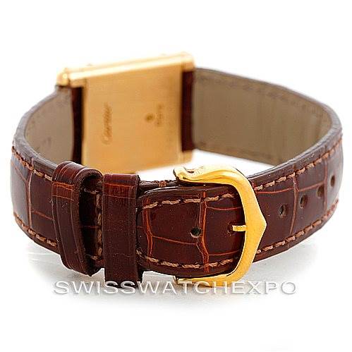 The image shows the back of the Cartier Tank Classic Women's Yellow Gold White Dial Women's Yellow Gold White Dial watch, emphasizing the brown leather strap and gold clasp.