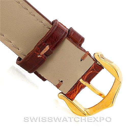 The image shows a close-up of the leather strap and gold buckle of a Cartier Tank Classic Women's Yellow Gold White Dial Women's Yellow Gold White Dial watch.