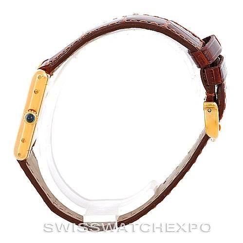 The image shows a side profile of the Cartier Tank Classic Women's Yellow Gold White Dial Women's Yellow Gold White Dial watch, highlighting the gold-toned case, sapphire crown, and brown leather strap.