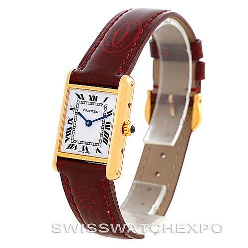 The image shows a Tank Classic model by Cartier at a three-quarter angle, highlighting the watch face, leather strap, and clasp.