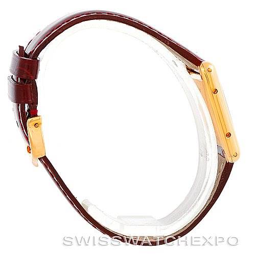 The image shows a side view of the Tank Classic Cartier watch, highlighting its leather strap and gold case.