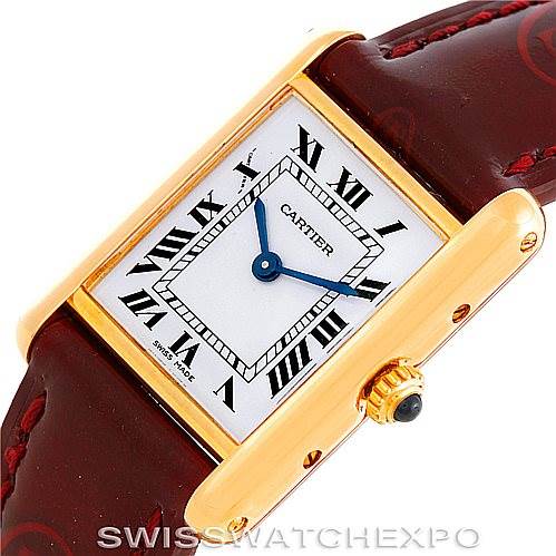 The image shows a close-up of a Cartier Tank Classic Women's Yellow Gold White Dial Women's Yellow Gold White Dial watch face, strap, and crown, angled slightly from the top-right.