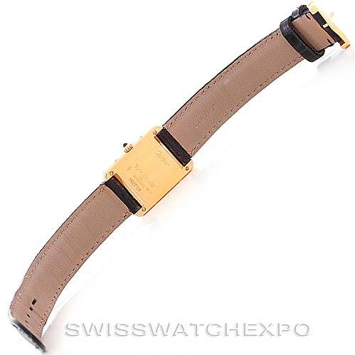 The image shows the back of the Cartier Tank Classic Women's Yellow Gold Silver Dial Women's Yellow Gold Silver Dial watch and its leather strap, highlighting the buckle and case back.