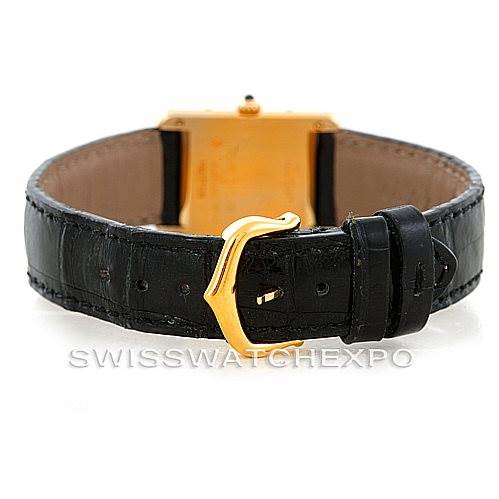 This image shows the back view of a Cartier Tank Classic Women's Yellow Gold Silver Dial Women's Yellow Gold Silver Dial watch, focusing on the black leather strap and gold buckle.