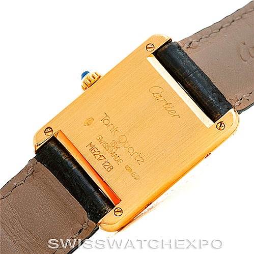 This image shows the back of a Cartier Tank Classic Women's Yellow Gold Silver Dial Women's Yellow Gold Silver Dial watch and part of its leather strap from a top-down angle.