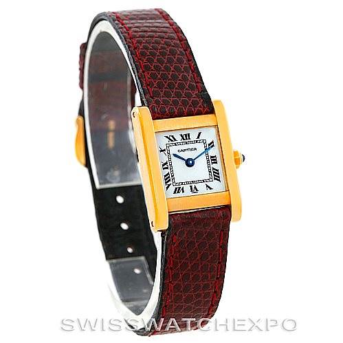 This image shows a Cartier Tank Classic Women's Yellow Gold White Dial Women's Yellow Gold White Dial watch from a front angle, highlighting its gold rectangular case and red textured leather strap.