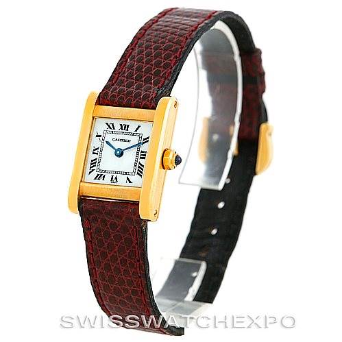 The image shows a Cartier Tank Classic Women's Yellow Gold White Dial Women's Yellow Gold White Dial watch from a side angle, highlighting the watch face, gold casing, and the red leather strap.