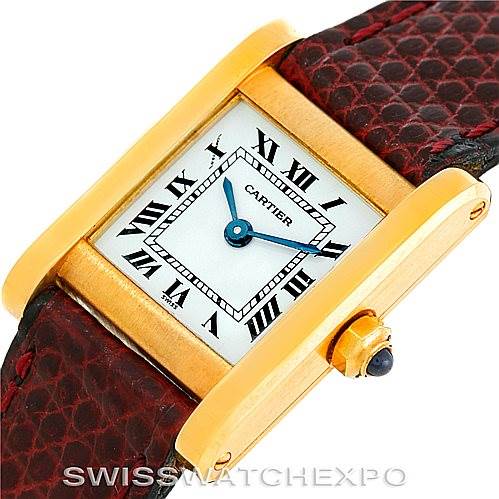 This image shows a close-up angle of the Cartier Tank Classic Women's Yellow Gold White Dial Women's Yellow Gold White Dial watch, highlighting its gold case, Roman numeral dial, and leather strap.