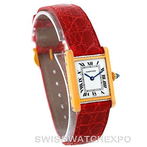 This image shows a Cartier Tank Classic Women's Yellow Gold White Dial Women's Yellow Gold White Dial watch at a 3/4 angle, highlighting the dial, crown, and red leather strap.