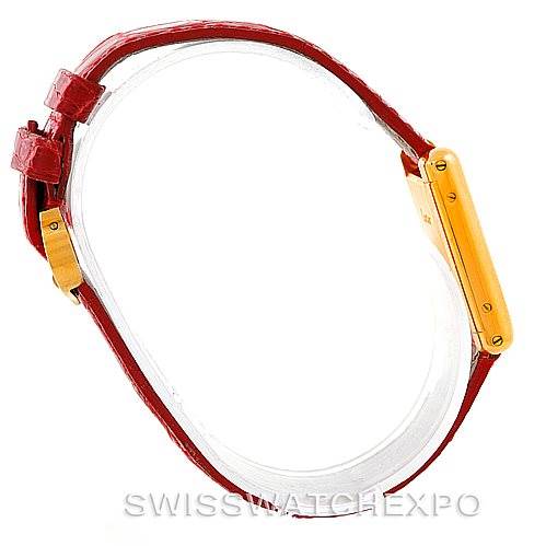 The image shows a side view of a Cartier Tank Classic Women's Yellow Gold White Dial Women's Yellow Gold White Dial watch with a red leather strap.