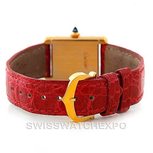 This image shows the back view of a Cartier Tank Classic Women's Yellow Gold White Dial Women's Yellow Gold White Dial watch, highlighting its red leather strap and gold buckle.