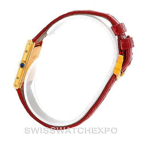 The image shows a side angle of the Cartier Tank Classic Women's Yellow Gold White Dial Women's Yellow Gold White Dial watch's case and red leather strap.