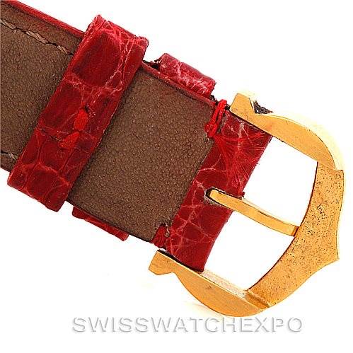 The image shows a close-up of the red leather strap and gold buckle of a Cartier Tank Classic Women's Yellow Gold White Dial Women's Yellow Gold White Dial watch.