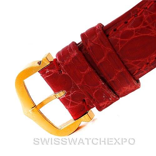 The image shows a close-up of the red leather strap and gold buckle of a Cartier Tank Classic Women's Yellow Gold White Dial Women's Yellow Gold White Dial model watch.