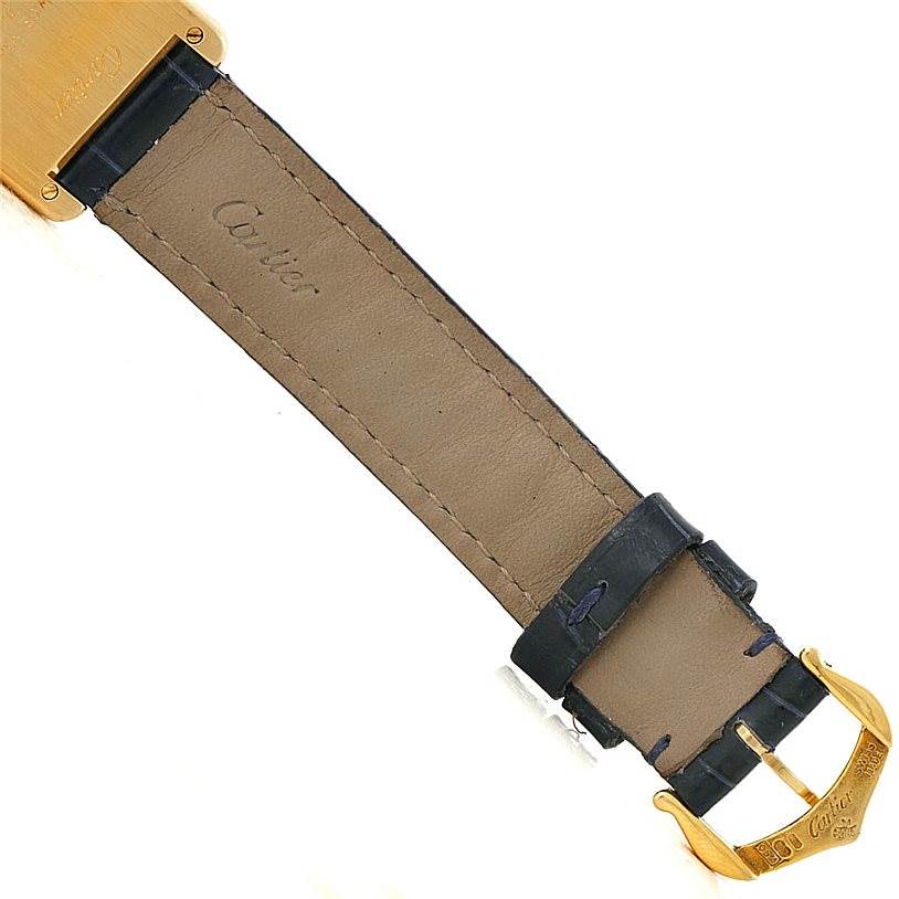 This is a close-up of the underside of the leather strap and the buckle of a Cartier Tank Classic Women's Yellow Gold Silver Dial Women's Yellow Gold Silver Dial model watch.