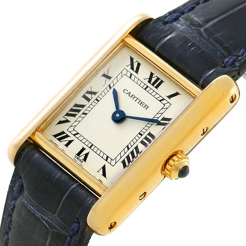 This image shows a Cartier Tank Classic Women's Yellow Gold Silver Dial Women's Yellow Gold Silver Dial watch from a slightly tilted angle, highlighting its face, Roman numerals, and black leather strap.