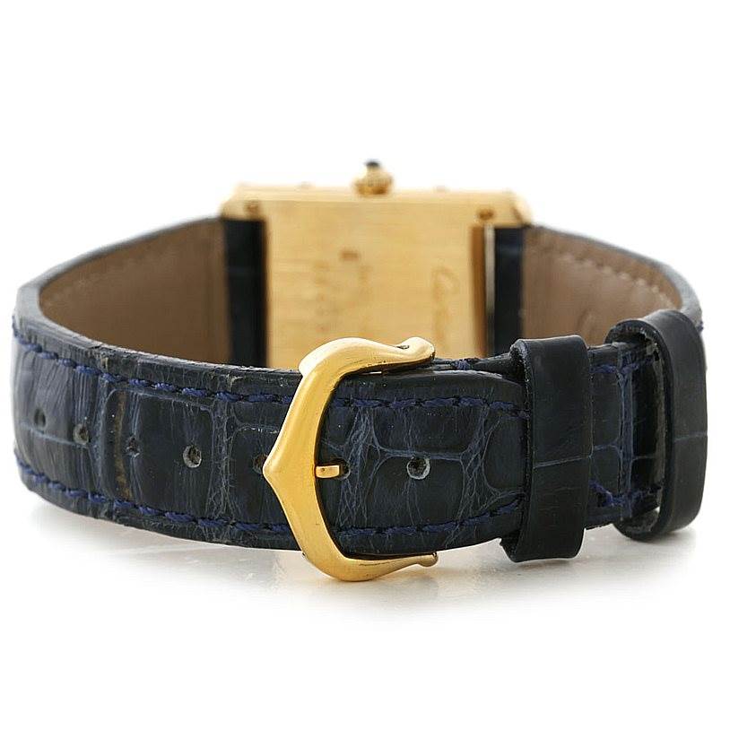 The image shows the back of the Cartier Tank Classic Women's Yellow Gold Silver Dial Women's Yellow Gold Silver Dial watch with a blue leather strap and gold buckle.