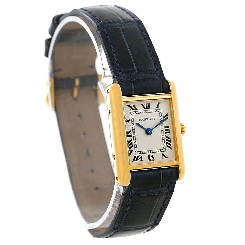 The Cartier Tank Classic Women's Yellow Gold Silver Dial Women's Yellow Gold Silver Dial watch is shown at an angle highlighting its rectangular face, Roman numeral dial, and black leather strap.