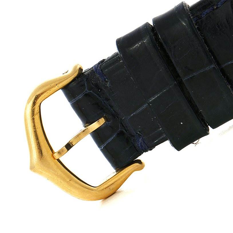 This image shows a close-up of the black leather strap and gold buckle of the Cartier Tank Classic Women's Yellow Gold Silver Dial Women's Yellow Gold Silver Dial model watch.