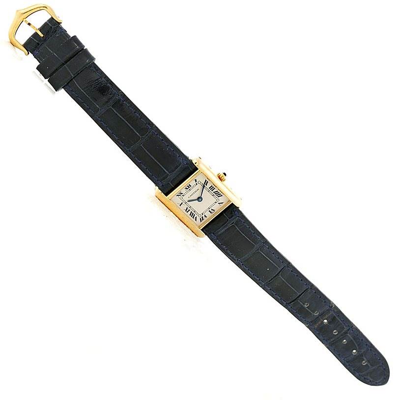 The image shows the Cartier Tank Classic Women's Yellow Gold Silver Dial Women's Yellow Gold Silver Dial watch laid flat from a top-down angle, displaying the strap, case, and dial.