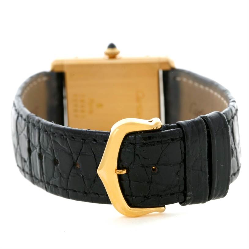 This image shows the back view of the Cartier Tank Classic Yellow Gold White Dial Yellow Gold White Dial watch, focusing on the black strap and gold buckle.