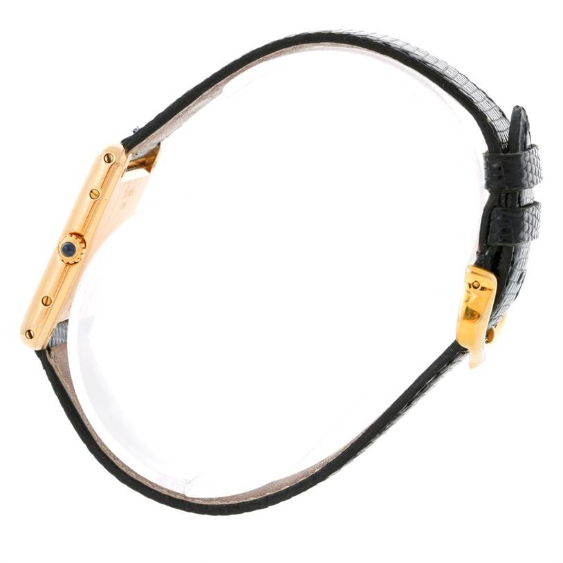 This image shows a side profile of the Cartier Tank Classic Yellow Gold Beige Dial Yellow Gold Beige Dial watch, highlighting the case, bezel, and black leather strap.