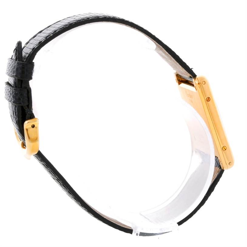 Side angle showing the gold case, side screws, black leather strap, and buckle of the Cartier Tank Classic Yellow Gold Beige Dial Yellow Gold Beige Dial watch.