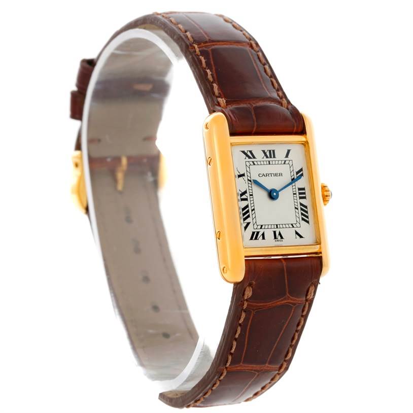 The Cartier Tank Classic Women's Yellow Gold Silver Dial Women's Yellow Gold Silver Dial watch is shown at a slight angle, displaying the face, hands, brown leather strap, and gold casing.