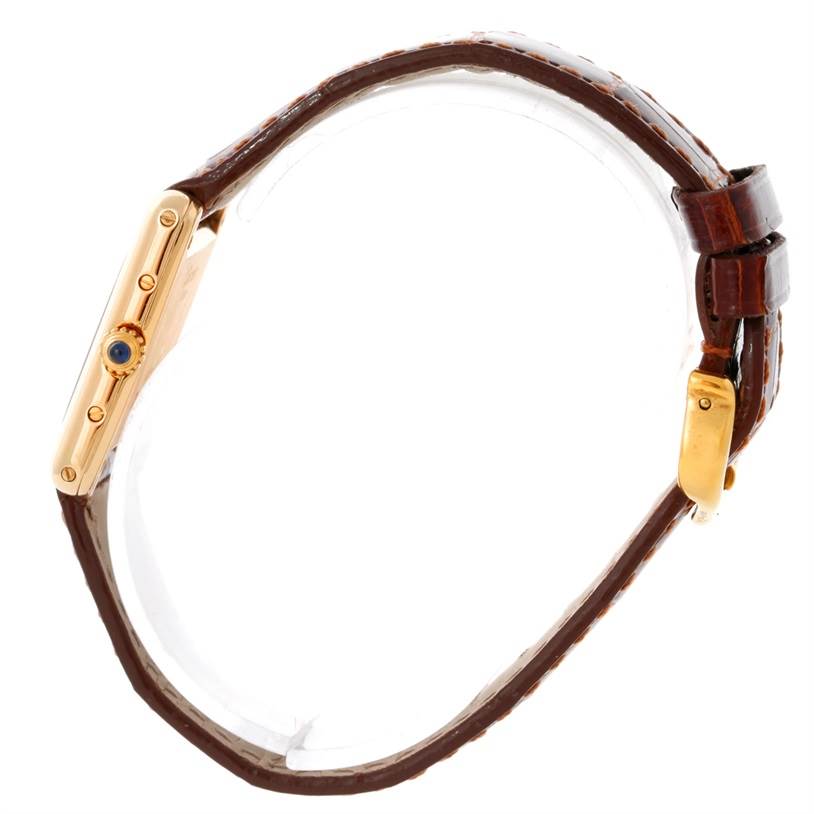 The image shows a side view of a Cartier Tank Classic Women's Yellow Gold Silver Dial Women's Yellow Gold Silver Dial watch, highlighting the gold case, crown, and brown leather strap.