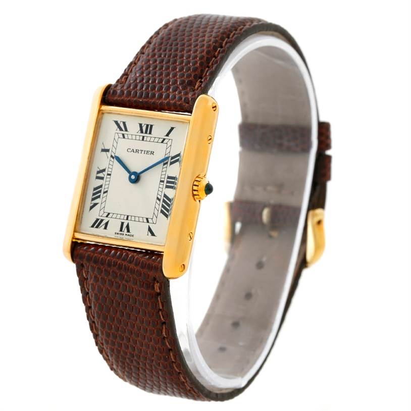 The image shows a Cartier Tank Classic Yellow Gold Beige Dial Yellow Gold Beige Dial watch from a three-quarter angle highlighting the face, case, crown, and leather strap.