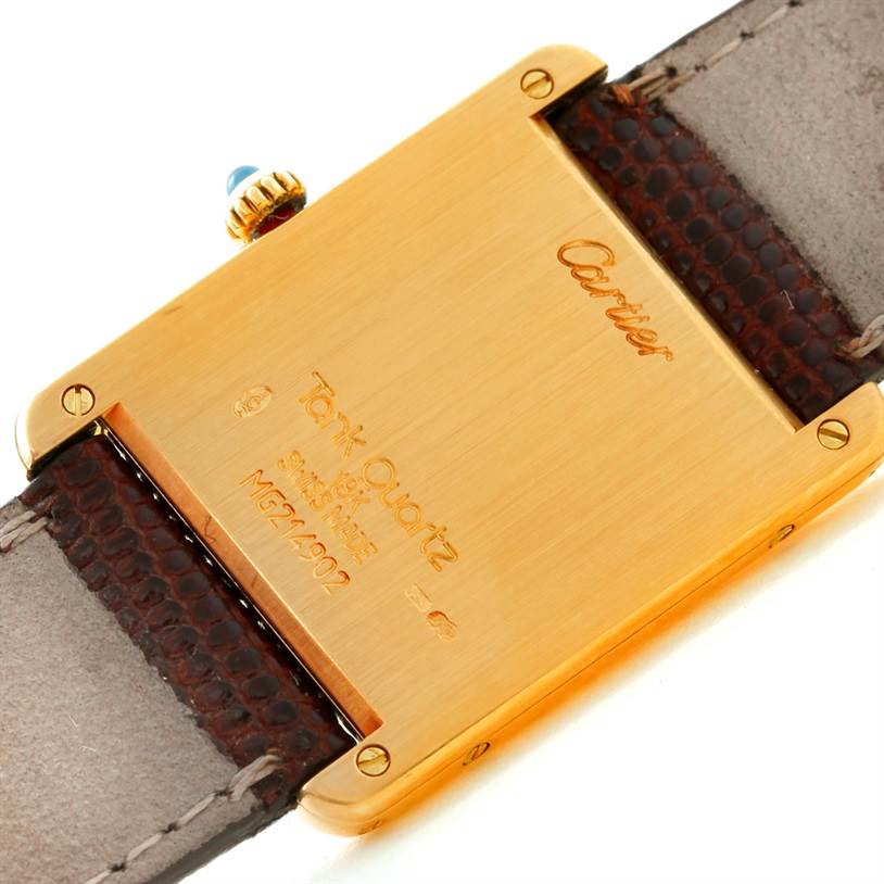 The image shows the back of a Tank Classic watch by Cartier, focusing on its caseback and leather strap.