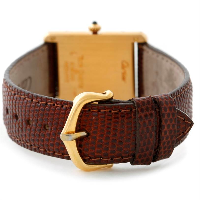 This image shows the back of the Cartier Tank Classic Yellow Gold Beige Dial Yellow Gold Beige Dial watch, highlighting the brown strap and gold buckle.