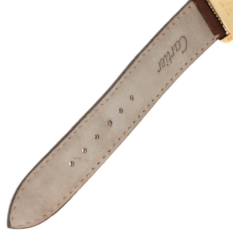 The image shows a close-up of the leather strap with the "Cartier" logo for the Cartier Tank Classic Yellow Gold Beige Dial Yellow Gold Beige Dial model.