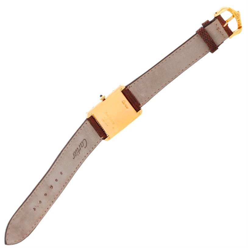 The image shows the back view of a Cartier Tank Classic Yellow Gold Beige Dial Yellow Gold Beige Dial watch, displaying its buckle, strap, and caseback.