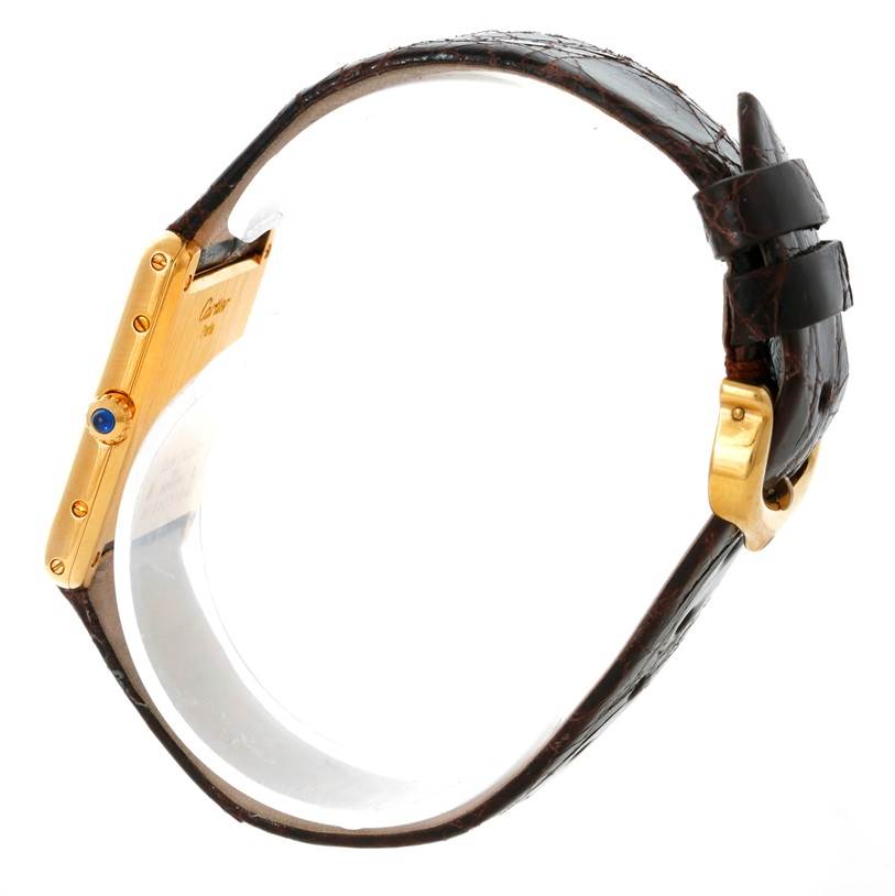 This side view of the Tank Classic model watch by Cartier shows the case, crown, and leather strap with buckle.