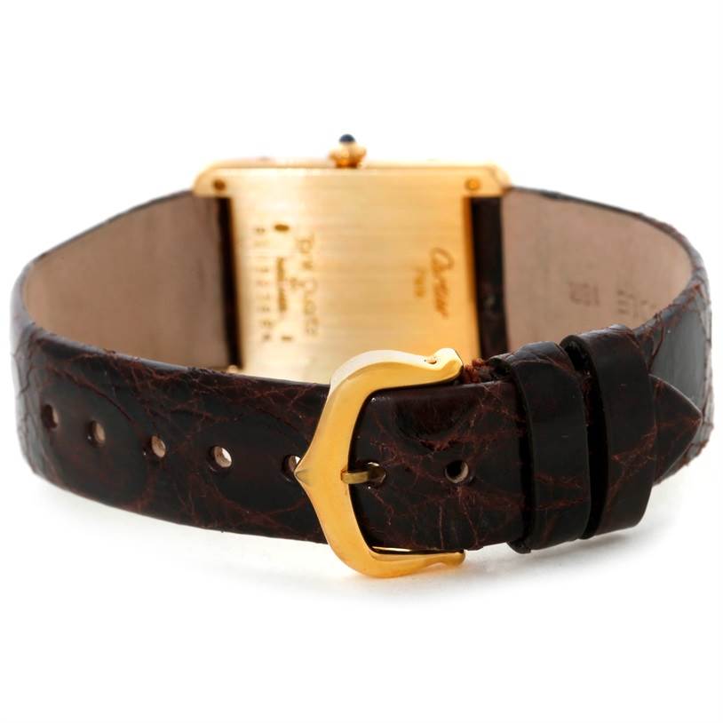 This image shows the back view of a Cartier Tank Classic 8810527329 Yellow Gold White Dial 8810527329 Yellow Gold White Dial watch, highlighting the case back and leather strap.