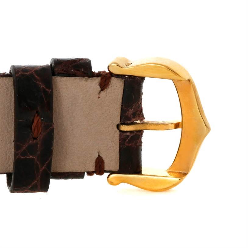 This image shows a close-up of the buckle and part of the leather strap of a Cartier Tank Classic 8810527329 Yellow Gold White Dial 8810527329 Yellow Gold White Dial watch.