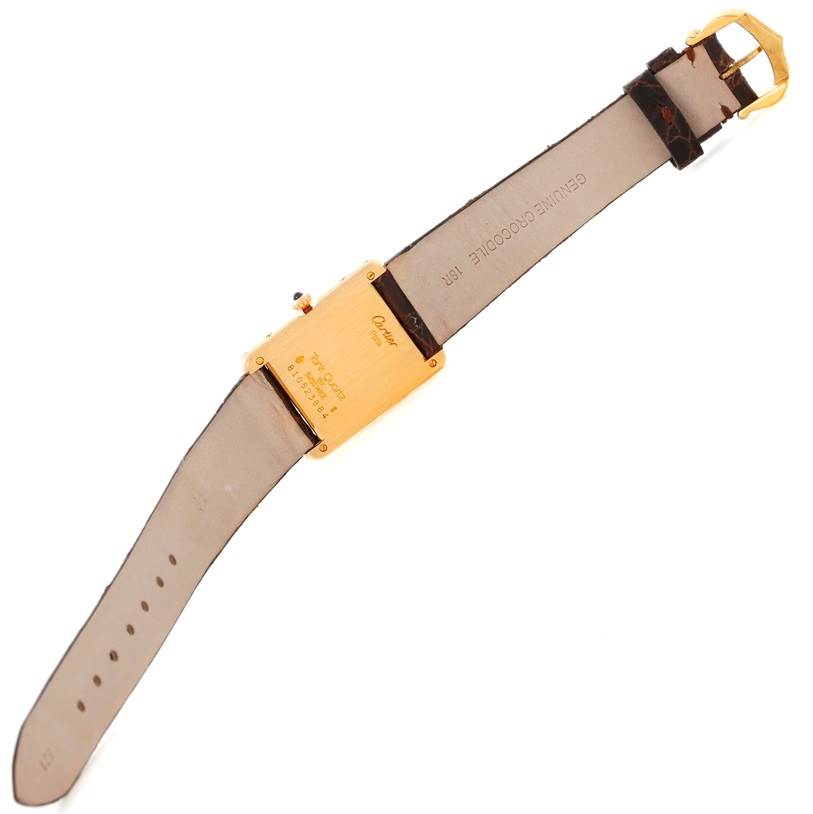 The image shows the back view of the Cartier Tank Classic 8810527329 Yellow Gold White Dial 8810527329 Yellow Gold White Dial watch, highlighting its backside and leather strap.