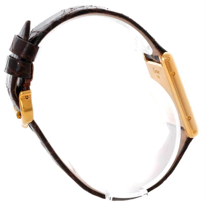 The image shows a side profile of the Cartier Tank Classic 8810527329 Yellow Gold White Dial 8810527329 Yellow Gold White Dial watch, highlighting its strap, buckle, and case.