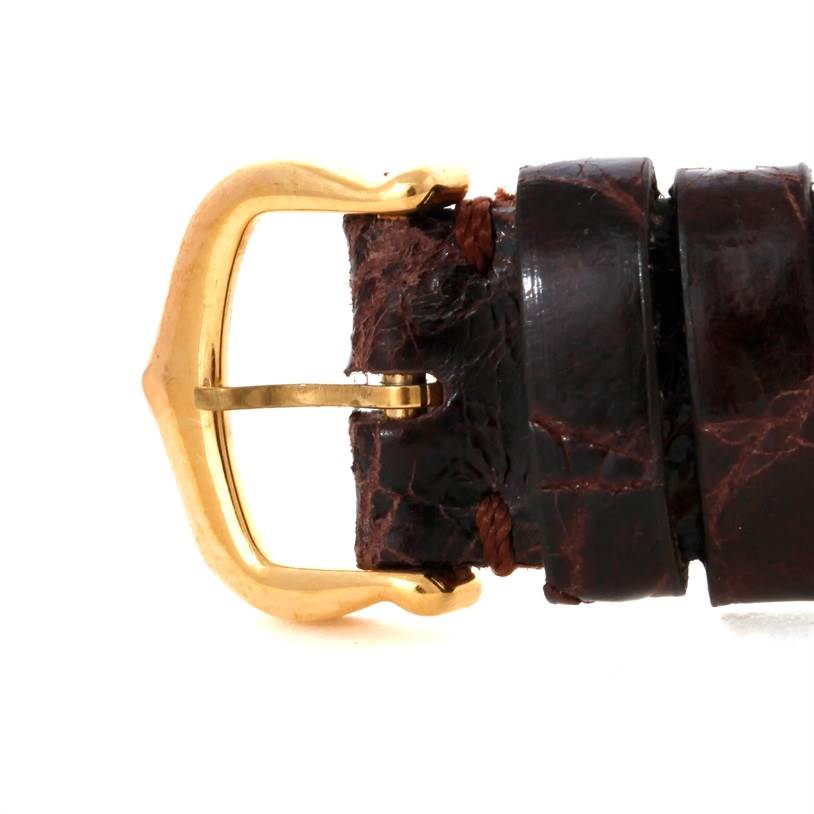 This image shows a close-up side view of the buckle and leather strap of a Cartier Tank Classic 8810527329 Yellow Gold White Dial 8810527329 Yellow Gold White Dial watch.